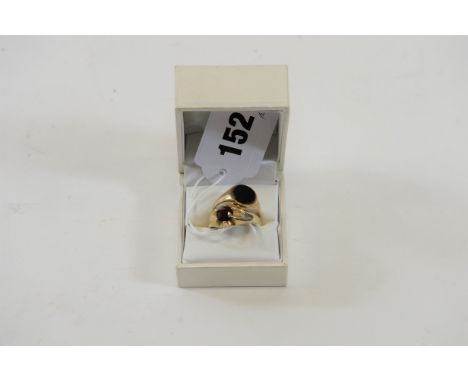 A GENTS 9CT GOLD RING SET with a garnet and a gents 9ct gold oval black onyx SIGNET RING, approximately 6.3 grams.  (2)   £50