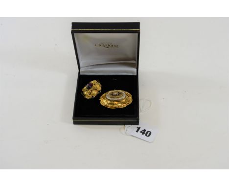 A VICTORIAN YELLOW METAL FILIGREE BROOCH with central cabochon garnet, 8.5 grams and a Victorian yellow metal and enamel MOUR