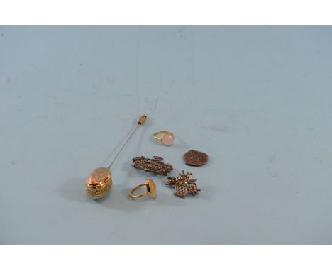 A GILDED OVAL ENGRAVED AND PIERCED TURBAN PIN, a Chinese HAT FINIAL, a yellow metal RING set with a rutilated stone, another 