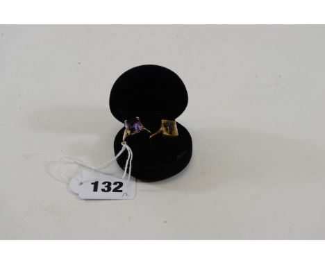 A 9CT GOLD CITRINE SET DRESS RING and a ditto 9ct gold amethyst DRESS RING, approximately 7.3 grams.  (2)   £50-£75