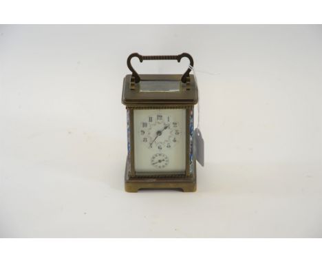 AN EARLY 20TH CENTURY BRASS 8 DAY CARRIAGE CLOCK with champleve enamel struts, cream floral enamel dial with subsidiary alarm