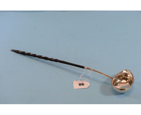 A GEORGE III SILVER PUNCH LADLE with oval beaded edge bowl and twisted whalebone handle with silver terminal, maker:- CH, Lon