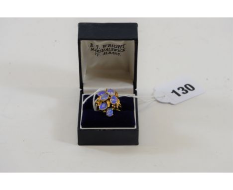 AN 18K YELLOW FOLIATE DESIGN RING SET with six oval opals, stamped 18k.   £180-£250