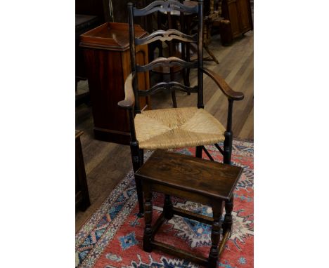 AN EARLY 20TH CENTURY OAK AND ASH PIERCED LADDER BACK ARMCHAIR with rush seat and a 20th Century oak JOINT STOOL, raised on t