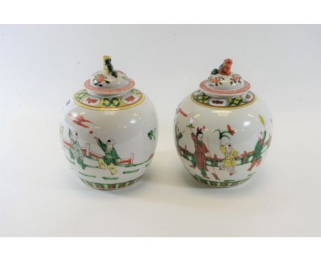 A PAIR OF REPUBLICAN PERIOD CHINESE PORCELAIN OVOID JARS AND COVERS decorated with figures at play in bright enamelled colour