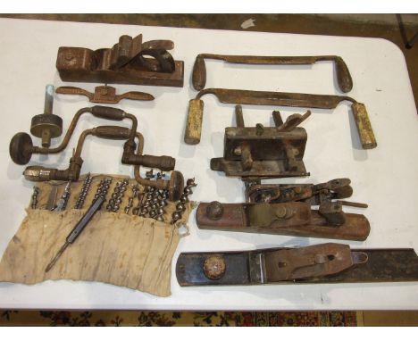 Two braces and a collection of auger bits, a wood, iron and brass plane and other tools.