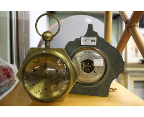 A brass and glass domed lens desk clock, together with a slate cased barometer.