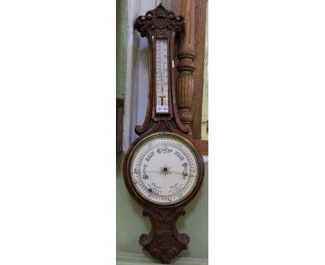 A walnut carved barometer thermometer