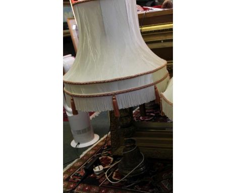 An fancy cast metal lamp with shade