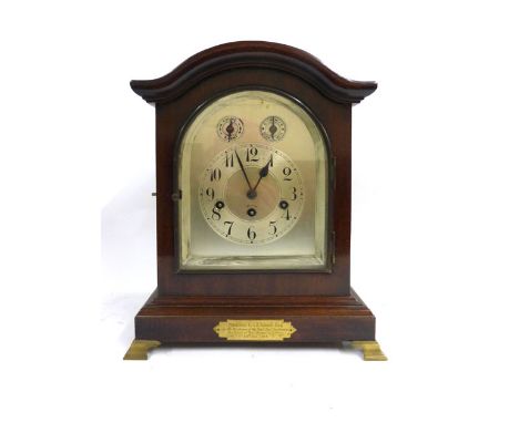 An early 20th century mantle clock, the Junghans movement chiming and striking on a gong, the silvered dial within a brass mo