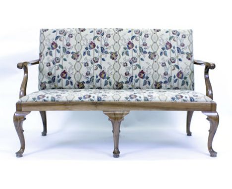 An early 18th century-style two seater sofa, the upholstered seat and back supported by satin walnut arms and cabriole feet  