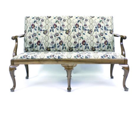 An early 18th century-style two seater sofa, the upholstered seat and back supported by satin walnut arms and cabriole feet  