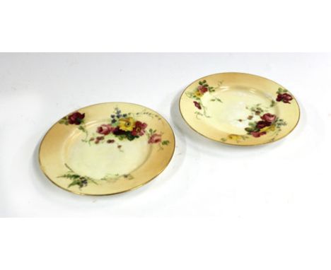 A pair of Royal Worcester saucer dishes, typically decorated with floral sprays on a blush ivory ground, pdcm 1910, d. 15 cm 