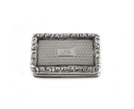 A William IV silver and parcel gilt vinaigrette of typical cushioned rectangular form, engine turned within a foliate border 