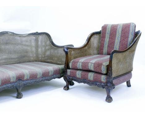 A late 19th century walnut and double bergere three piece suite with carved frames and ball and claw feet   CONDITION REPORT: