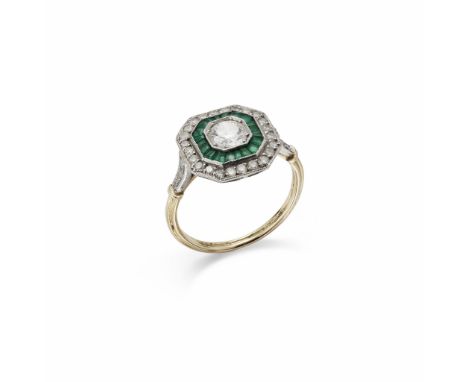 A DIAMOND AND EMERALD TARGET CLUSTER RING The brilliant-cut diamond centre millegrain-set within an octagonal two tier surrou