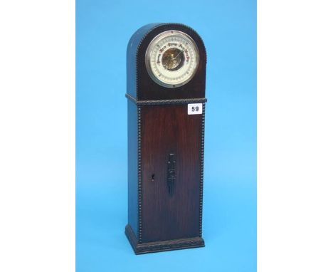 A barometer set in a 1930's oak Art Deco style clock case. 48cm height
