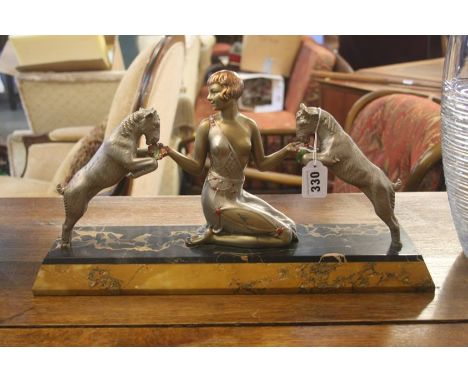 A Continental Art Deco figure group of a lady and two goats