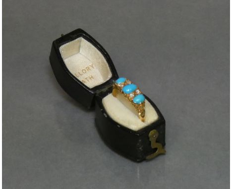 A late Victorian gold ring set three graduated turquoise cabochons with pairs of small diamonds in between (hallmarks rubbed)