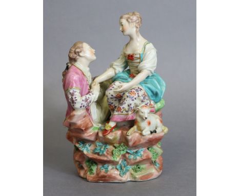 A Derby porcelain figure group “La Bergere des Alpes”, after the model by Etienne Falconet, depicting two lovers embracing on