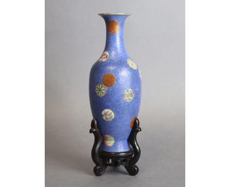 A Chinese porcelain slender ovoid vase of blue ground with all-over sgraffito scroll decoration, &amp; scattered roundels pai