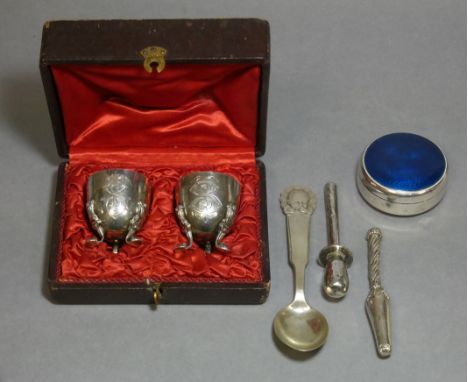 A pair of French .950 standard egg cups with engraved monograms, each on three foliate scroll feet, 2” high, in fitted case; 