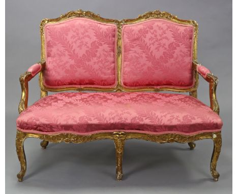An 18th century style French carved giltwood frame sofa upholstered rose-pink silk damask, on six cabriole legs, 50” wide x 3