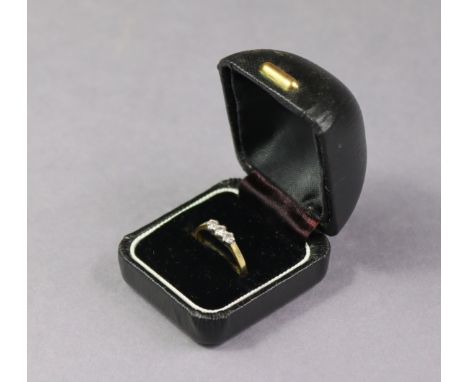 An 18ct. Gold ring set row of three small diamonds; size: L; weight: 2.3 gm.