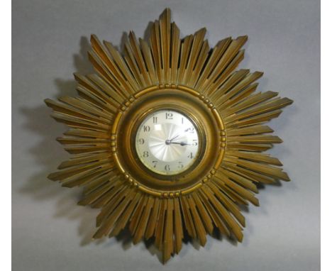 An early/mid-20th century wall timepiece in giltwood sunburst case, with French eight-day movement, the 3¼” dia. silvered dia
