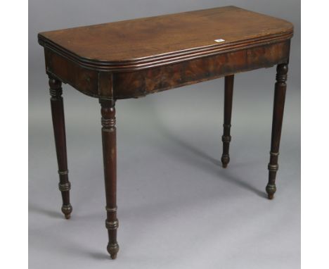 A 19th century mahogany tea table with moulded edge &amp; rounded corners to the rectangular fold-over top, &amp; on four rin