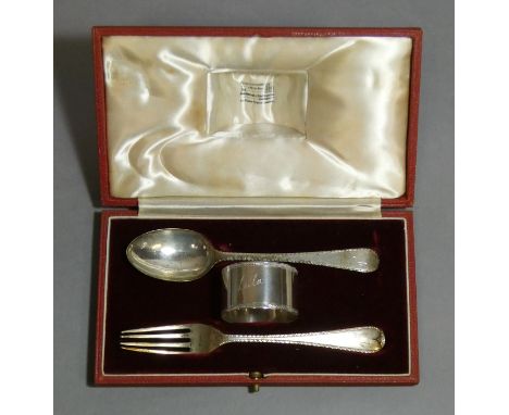 A silver christening set of feather-edge spoon, fork, &amp; napkin ring, in fitted case; London 1936 by Goldsmiths &amp; Silv