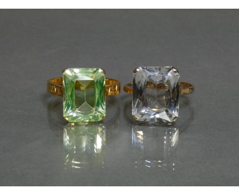 A Chinese 22K ring set rectangular-cut pale green stone, size P, weight 6.3g; &amp; a 9K ring set rectangular-cut white stone