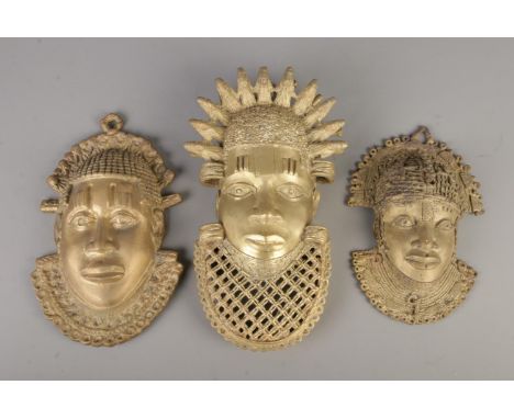 Three Nigerian brass tribal wall masks. Approx. height of largest 34cm.
