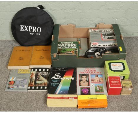A box of photography equipment and books, including Philips exposure timer, Expro RF-154 foldable light reflector, Halina No.