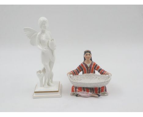 Seated ceramic female figure holding a large basket stamped USSR and a Villeroy &amp; Boch limited edition figure of a fairy.