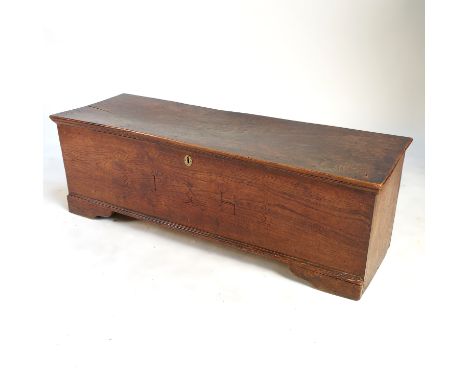 A 19th century elm sword box, or six plank coffer, with plain rising lid, raised on altered short bracket feet, width 46ins