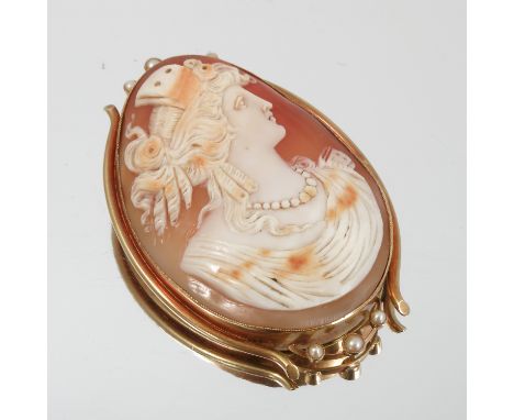 A 15ct gold mounted oval cameo brooch, carved with a female portrait, the gold mount set with half pearls, together with a pa