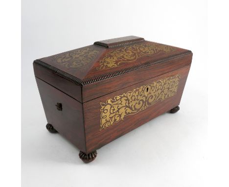 A Regency rosewood tea caddy, with cut brass inlaid decoration, having two cannisters to the interior with mixing bowl space,