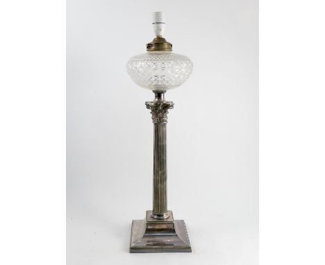 A silver plated table lamp, with reeded column raised on stepped base, with glass reservoir bowl over, height 24ins