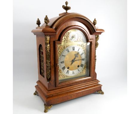 A 20th century walnut cased bracket clock, with striking movement, the brass arched face with subsidiary dial and silvered ch
