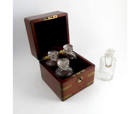 A 19th century mahogany decanter box, with brass recessed carrying handles and corners, with four associated decanters and la