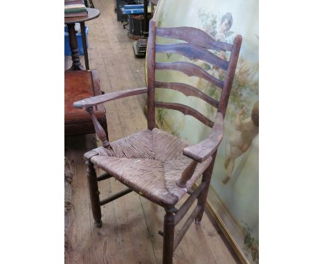Four ladder back chairs and three armchairs, by Gordon Russell, circa 1930s, with rush seats
