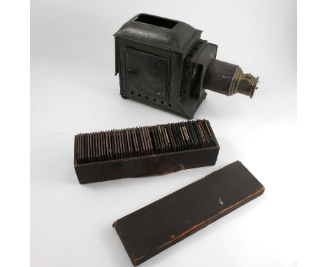 A Victorian magic lantern, together with a box of glass slides, showing photographic topographical views, printed stories, et