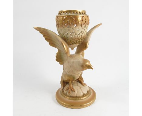 A Royal Worcester pot pourri, formed as a pierced vase supported in the wings of a bird Condition report: Slight damage, rest