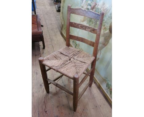 A set of twelve ladder back chairs, by Gordon Russell, circa 1930s, with rush seats