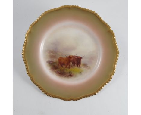A Royal Worcester plate, decorated with highland cattle in a rocky landscape, to a shaded gilt border, circa 1912, diameter 1