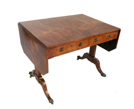 A Regency style rosewood sofa table, fitted with two drawers and two dummy drawers, raised on four out swept feet, with brass