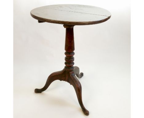A 19th century oak circular occasional table, raised on a tripod base, diameter 23ins