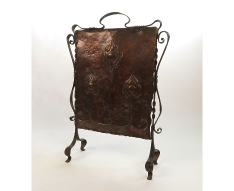 An Art Nouveau copper fire screen, decorated with three stylised flower heads, max width 21ins, height 31.5ins