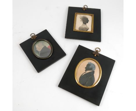 An oval portrait silhouette, of a man, in ebonised frame with gilt metal mounts, maximum diameter of portrait 3.25ins, togeth